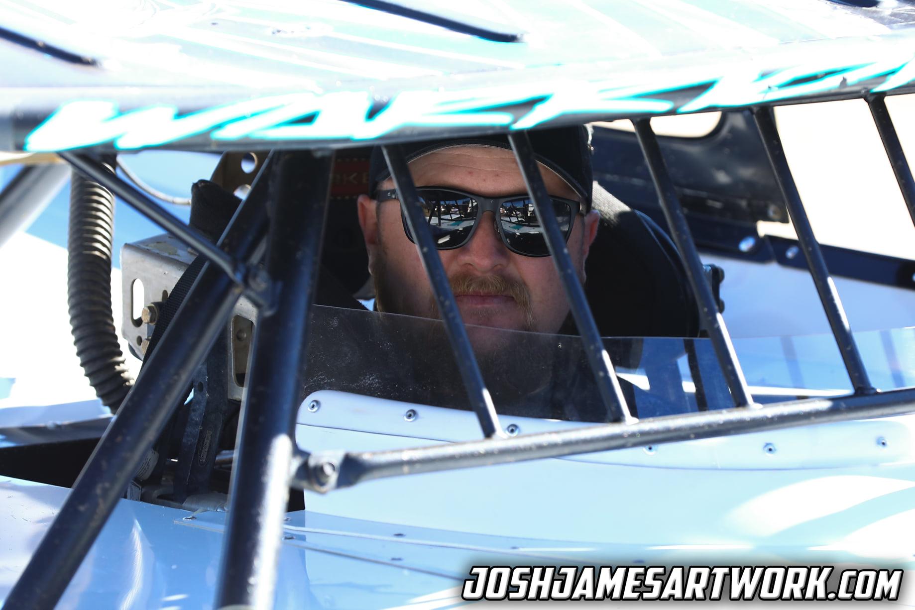 Ryan King in the driver's seat looking out through the window net