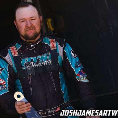 Studio portrait of Ryan King in his Warrior 1 Design firesuit
